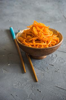 Organic spicy carrot salad on rustic table with copyspace as an organic food concept