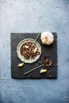 Peper grain spice on vintage plate on concrete background