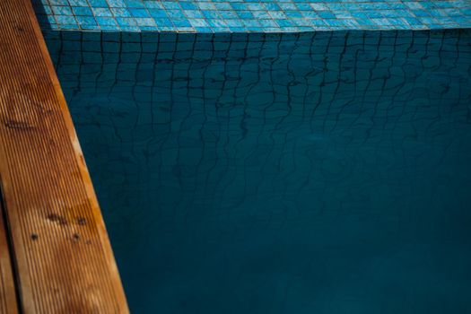 Blue swimming pool rippled water detail as a relax concept