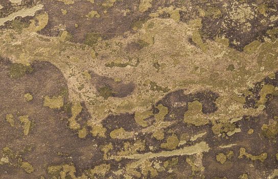 Weathered concrete wall. Abstract background from an old yellow wall damaged by the weather.