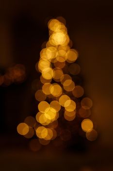 Bright golden bokeh lights in new year tree shape like overlay for your christmas design.