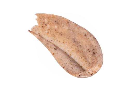 Peeling cream smudge with exfoliating particles. Cosmetic skincare product with abrasive particle sample, gentle nude scrub texture isolate. Scrub smear swatch isolated on white background.