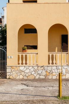 Typical yellow house facade part in italian city near the sea. Mediterranean village style architecture.