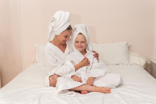Daughter love smiling mom dries bath thinks elbows coffee bathrobe, for girl hygiene in lifestyle for hotel caucasian, towel baby. Head kid fashion,