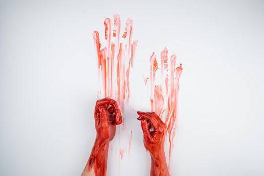 Female hands in blood on a white background