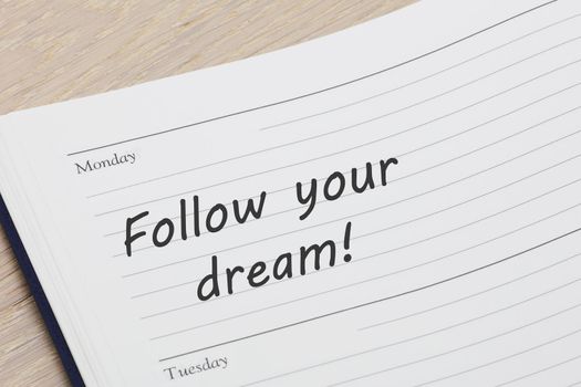 A Follow your dream diary reminder appointment open on desk