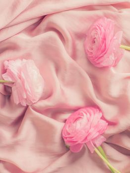 pink rose flowers on soft silk - wedding, holiday and floral background styled concept, elegant visuals