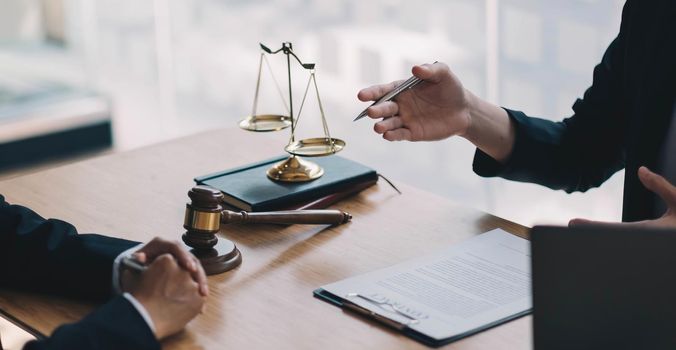 Lawyers give advice about judgment, agreements, Consultation of Businesswoman and Male lawyer or judge counselor having team meeting with client.