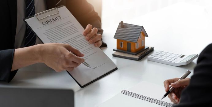 Business Signing a Contract Buy - sell house, Home for rent concept, broker agent presenting and consult detail to customer to making the decision a home estate loan to customer sign form agreement..