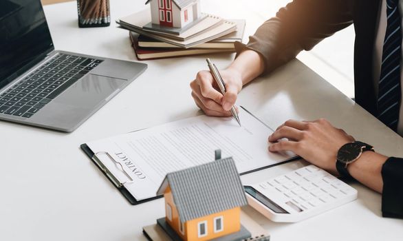 Business Signing a Contract Buy - sell house, Home for rent concept, broker agent presenting and consult detail to customer to making the decision a home estate loan to customer sign form agreement..