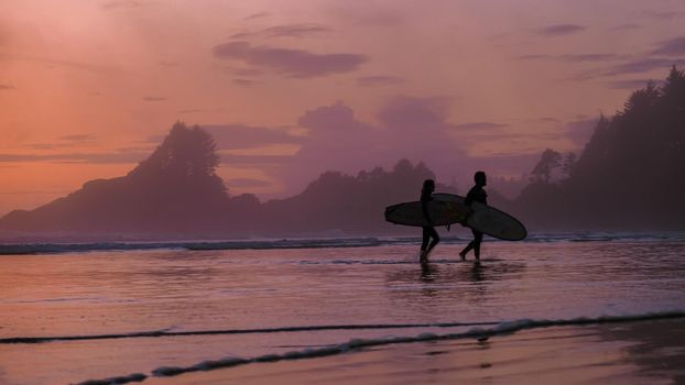 Tofino Vancouver Island Pacific rim coast, surfers with surfboard during sunset at the beach, surfers silhouette Canada Vancouver Island Tofino Vancouver Islander Island