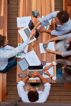 Im sure youll bring lots to the table. High angle shot of businesspeople shaking hands during a meeting outdoors