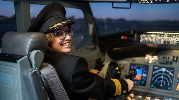 Female pilot on board the aircraft. Caucasian woman in flight simulator