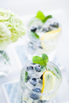 drinks, cocktails and celebration styled concept - cocktail with blueberry ice and lemon, elegant visuals