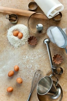 Baking ingredients and tools on a marble board in a kitchen