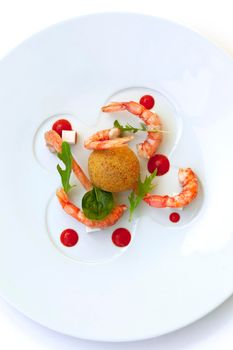 Risotto fritter, prawns and tomato sauce on a plate