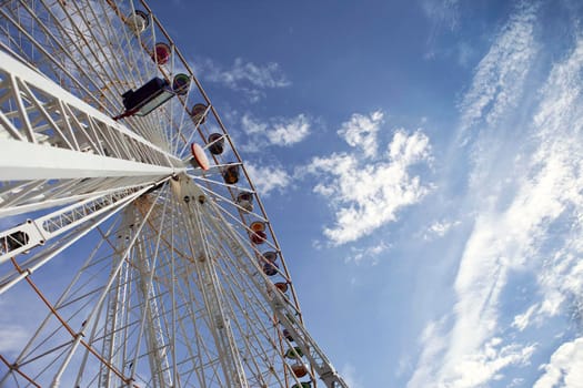 Big wheel and cloudy blue sky in a luna park