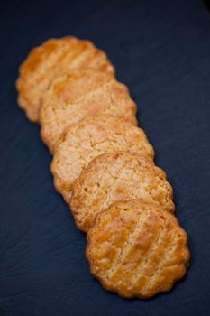 Crispy shortbread cookies on slate in a bakery