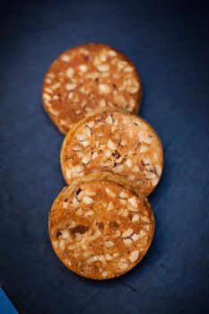 Crispy shortbread cookies and nuts on slate