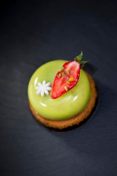 Pistachio mousse and strawberry on a biscuit