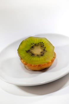 Close up of a kiwi cake on a porcelain plate