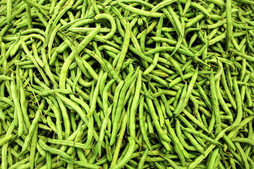 Heap of wet green (string) beans  displayed on food market.