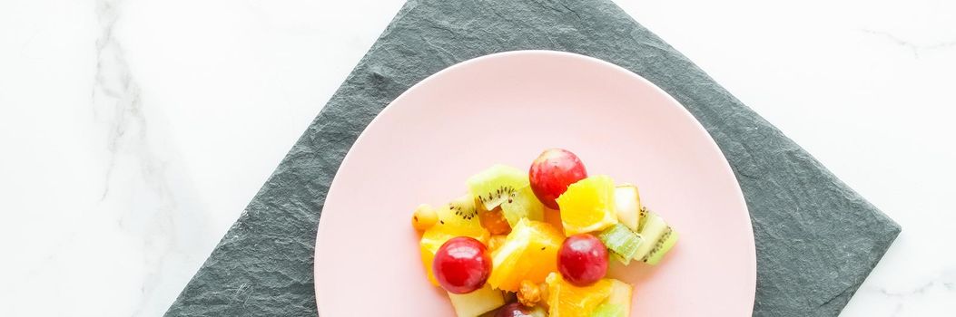 juicy fruit salad for breakfast on marble, flatlay - dieting and healthy lifestyle styled concept