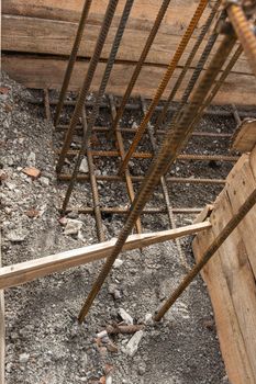 Reinforcement of the corner of the strip foundation, the trench is partially covered with earth