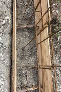 Partially buried bonded reinforcement and strip foundation formwork