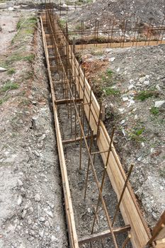 Fragment of reinforcement of a shallowly buried strip foundation of a low-rise residential building