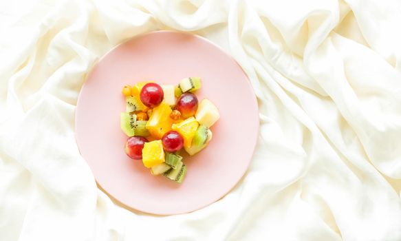 juicy fruit salad on silk, flatlay - healthy lifestyle and breakfast in bed styled concept