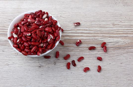 Red beans isolated on a wooden background