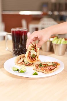 Girl eating delicious taco with salsa and a variety of toppings. Mexican taco with salsa, taco al pastor.