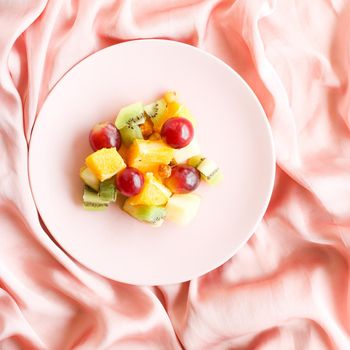 juicy fruit salad on silk, flatlay - healthy lifestyle and breakfast in bed styled concept