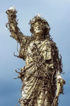 Grave statue covered in vines at Waverley Cemetery, a heritage-listed cemetery on top of the cliffs at Bronte in the eastern suburbs of Sydney, New South Wales, Australia.