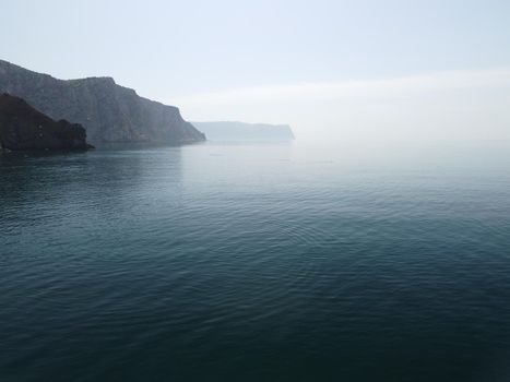 Aerial panoramic view of beautiful sunset above sea. Beautiful seascape. Sun glare, small waves on the water surface. Evening. Horizon. Nobody. No people. Copy space. Never-ending beauty of nature