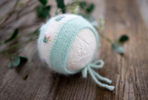 tender knitted for newborn on wooden background