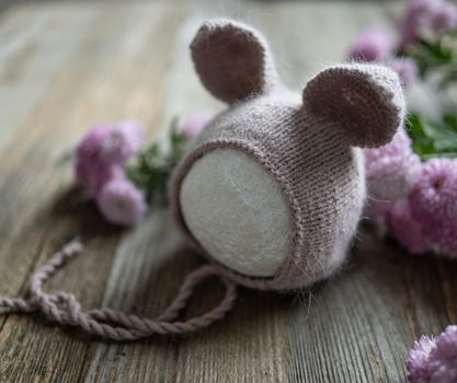 tender knitted for newborn on wooden background