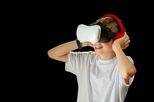 Teenager use modern technologies for entertainment or education. Kid in VR glasses, black background. Childrens in VR glasses singing with microphone. virtual Karaoke VR musician concept.