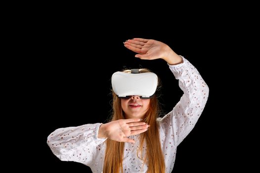 vr goggles and girl. Young woman in white shirt and jeans wearing virtual goggles. Woman standing with folded hands. Cyber technology and new virtual reality. metaverse and young generation banner on black background