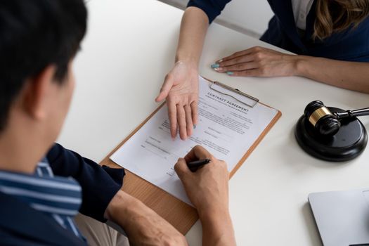 Business people negotiating a contract. Human hands working with documents at desk and signing contract