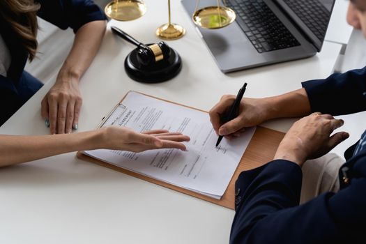 Business people negotiating a contract. Human hands working with documents at desk and signing contract