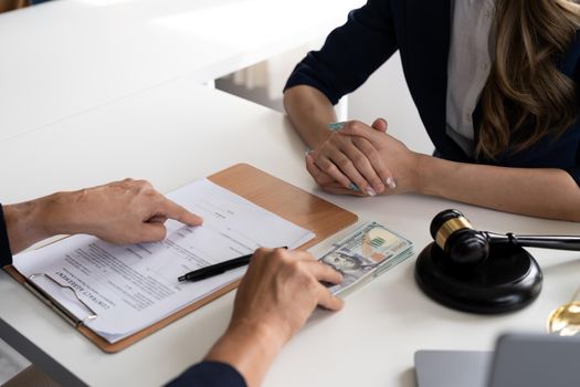 Business people negotiating a contract. Human hands working with documents at desk and signing contract