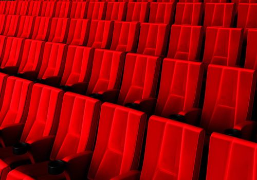 Rows of red velvet seats watching movies in the cinema with copy space banner background. Entertainment and Theater concept. 3D illustration rendering