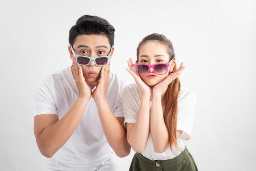 Close-up portrait of two nice attractive adorable cheerful people husband wife in eyeglasses eyewear touches cheeks with both hands over white background