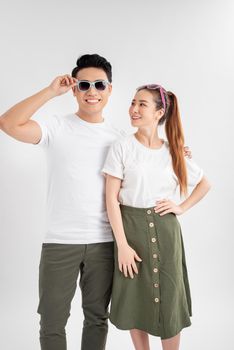 Surprised young couple looking at camera. Front view of excited young man and woman standing together and looking at camera on white background. Emotion concept