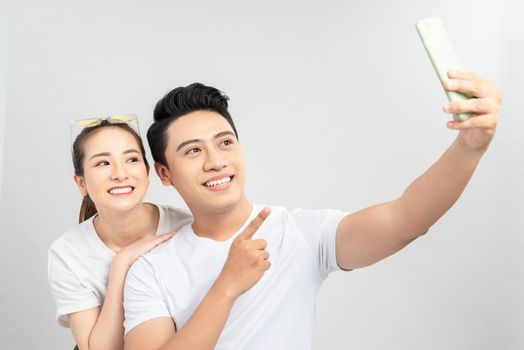 Beautiful curly woman making selfie with husband. Excited couple celebrating valentine's day.