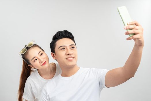 Beautiful young couple making selfie on smartphone