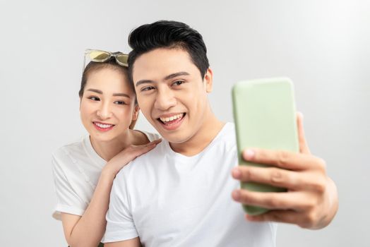 Beautiful young couple making selfie on smartphone