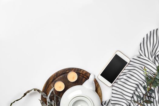 Still life with tea cup and the contents of a workspace composed. Different objects on white table. Flat lay. Top view. Copy space